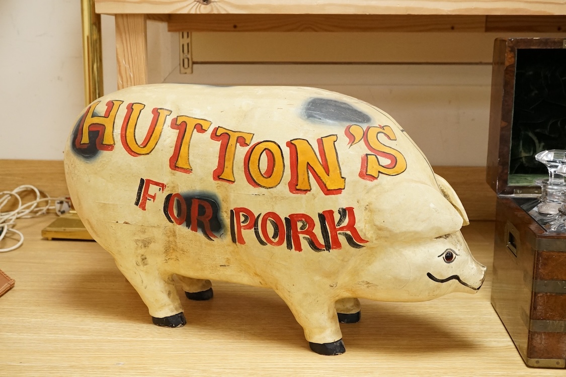 A painted wood butcher’s pig display model, inscribed Hutton’s for Pork and with examples of various cuts of meat to one side, 58cm wide